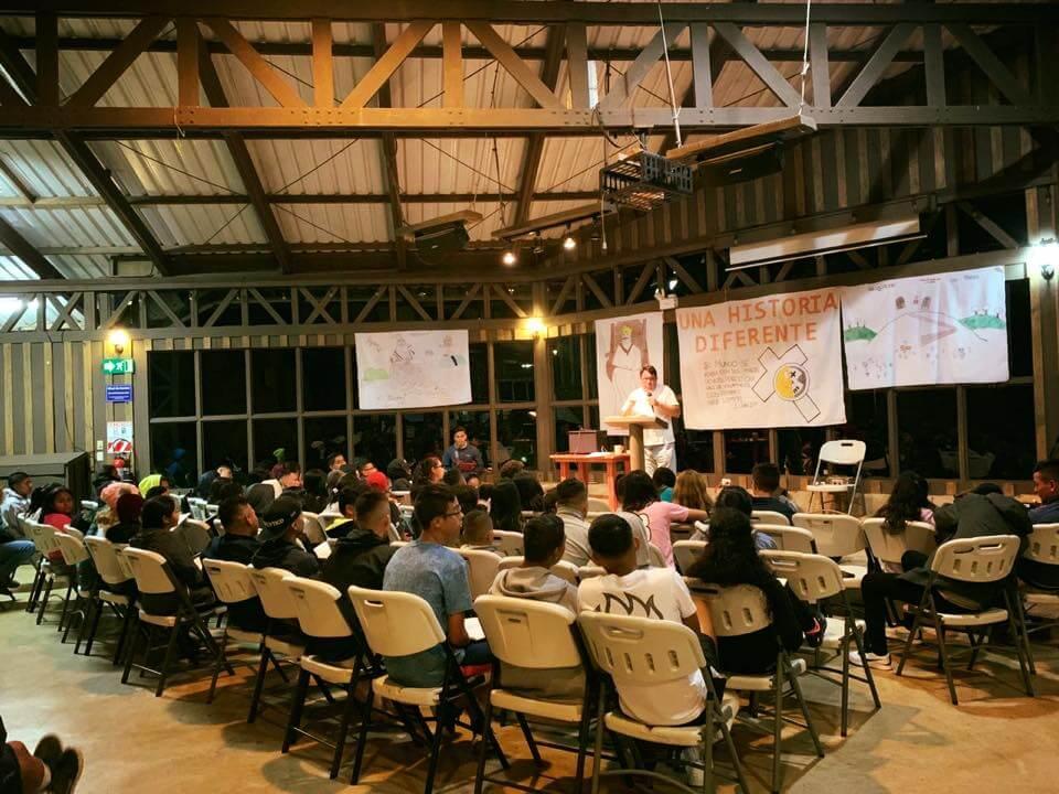 Group of people gathered for a Bible study inside a large amphitheater.